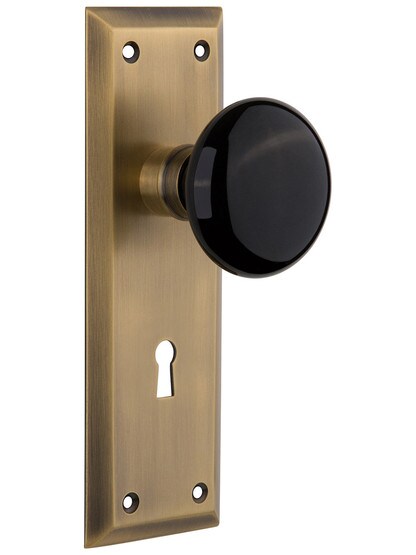 New York Plate with Black Porcelain Knob with Keyhole in Antique Brass.